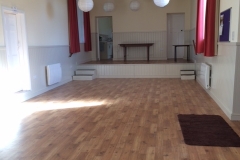 Main hall with new floor, heating, lighting and stage at far end